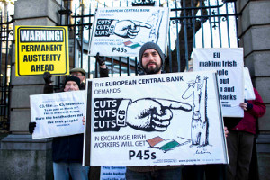 Protestors gather outside the Dáil after Budget 2013 was announced