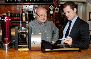 Publican Gerry Mulvaney from The Druid in Mountmellick with Kevin Moore, Diageo Connect Sales Team Representative, look over the new ordering system from Diageo Ireland.