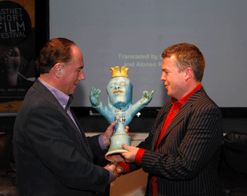 From left: Michael Barry, Managing Director of (festival title Sponsors) Corona distributors Barry & Fitzwilliam, presents the Festival Gong to Nick Kelly, formerly of the band The Fat Lady Sings and an enthusiastic participant in the Corona Fastnet Short Film Festival which took place in Schull in West Cork recently.