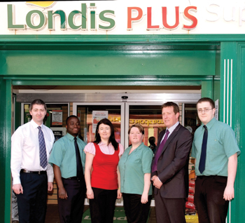 Stephen Mooney with the staff of Londis Plus, Swinford, and Shane Hopkins, regional manager ADM Londis