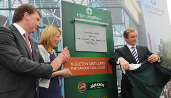 An Taoiseach Enda Kenny TD unveils the corner stone of the new Irish Distillers Ltd €100 million Midleton Distillery watched by IDL Chairman and Chief Executive Anna Malmhake and IDL Production Director Peter Moorehead.