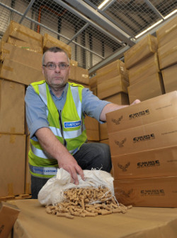Custom officer Matthew Hudson with 38 million cigarettes with a retail value of EUR*14.7m seized by customs officers in Dublin Port last year. New proposed regulations by the EU are likely to grow the black market in cigarettes even further