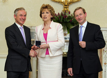 Fresh start? The new Fine Gael Minister for Enterprise Jobs and Innovation Richard Bruton receiving his seal of office from President Mary McAleese at Aras an Uachtarain as Taoiseach Enda Kenny looks on