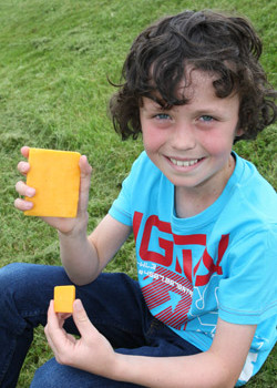 Ten year old Max Guilfoyle from Dublin shows the size of a 10g portion of cheese, the average daily intake of cheese reported for Irish children and teenagers as opposed to a 100g portion which is the amount used by the BAI when ruling on broadcasting regulations