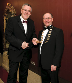 Joe Mannion, immediate past president of CSNA passing the chains of office to CSNA President Liam O'Connor.