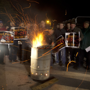 Members of the Irish Farmers Association, keep warm around a fire while holding a 24 hour protest outside Meadow Meats in Rathdowney in County Laoise.