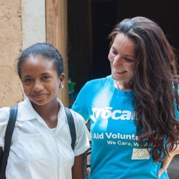 Trocaire volunteer Giulia Vuillermoz with Honduran schoolgirl Digna, in front of her home